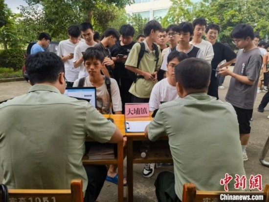 專武干部在發(fā)放兵役登記證。韋碩 攝