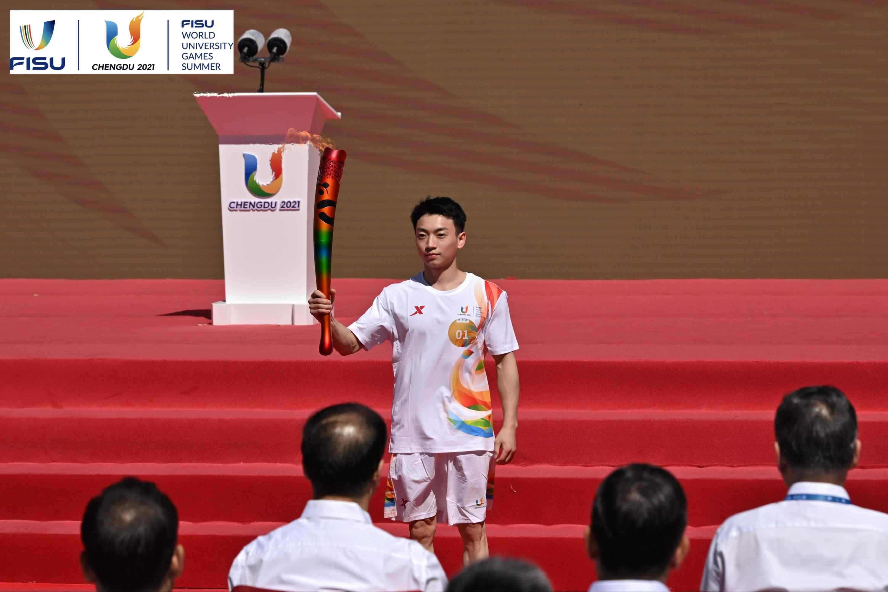 成都大運會火炬手、奧運冠軍鄒敬園高舉火炬。 圖片來源：成都大運會執(zhí)委會供圖