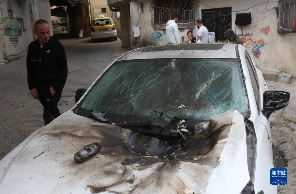 12月17日，在約旦河西岸城市圖勒凱爾姆附近的一處難民營(yíng)，人們查看在沖突中損毀的車(chē)輛。新華社發(fā)（尼達(dá)爾·艾仕塔耶?dāng)z）