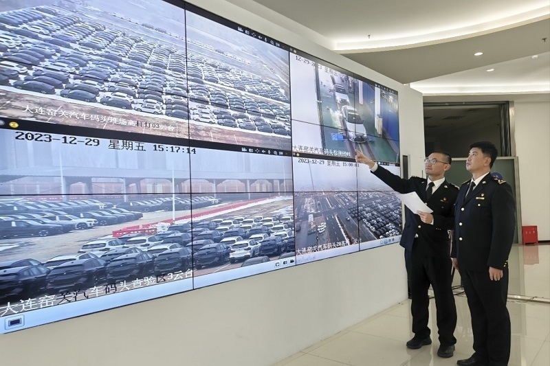 海關(guān)關(guān)員視頻巡查出口汽車場地。李進攝