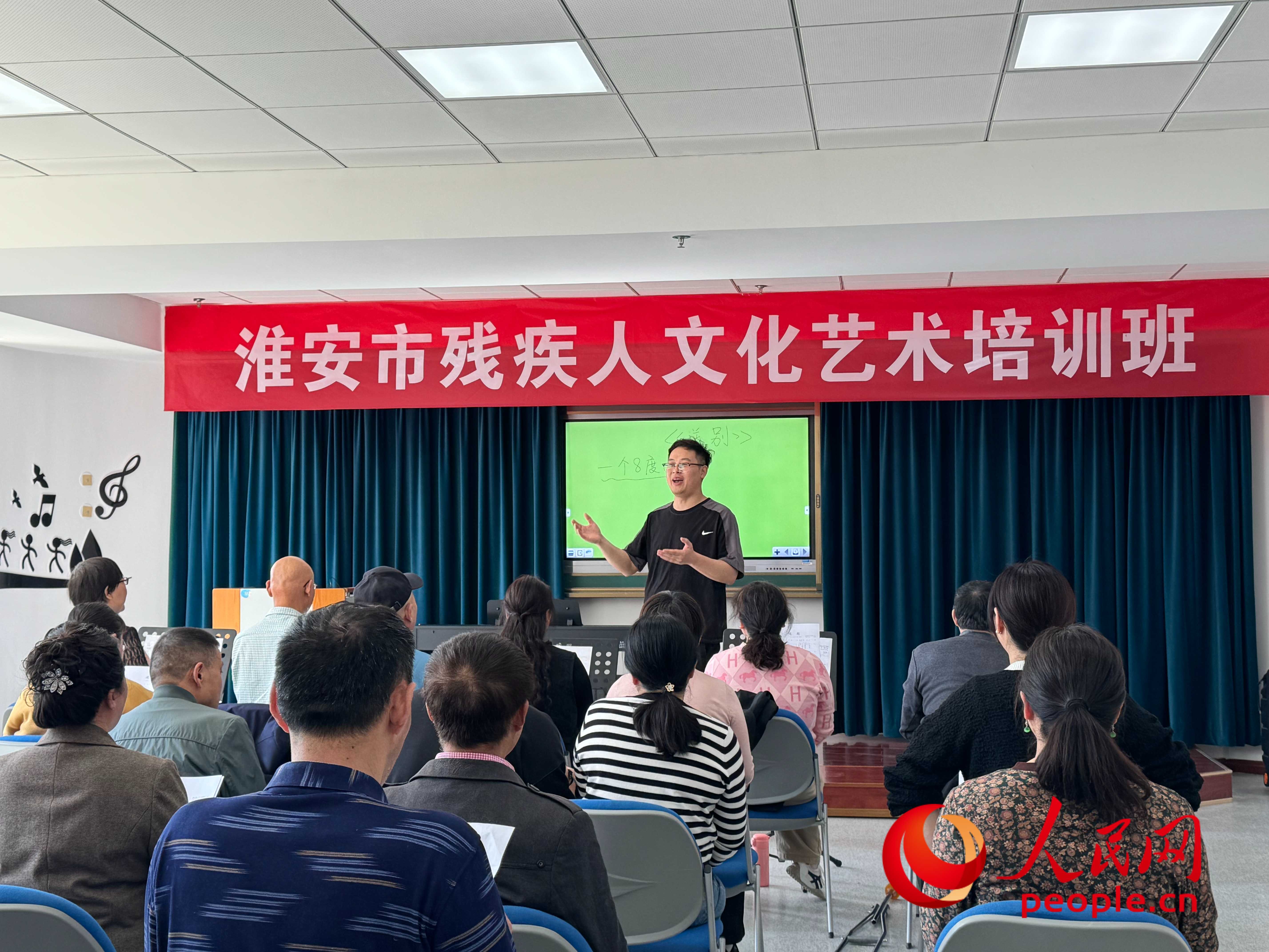 在淮安市殘疾人文化藝術(shù)培訓(xùn)班上，聲樂老師在教殘疾人唱《送別》這首歌曲。人民網(wǎng) 周靜圓攝