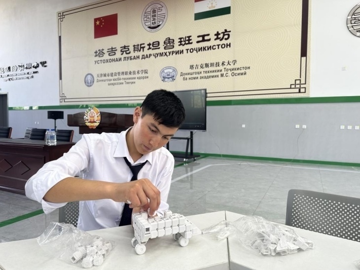 在塔吉克斯坦魯班工坊內(nèi)，學(xué)員正在操作能力源創(chuàng)新套件。本報(bào)記者 屈佩 攝