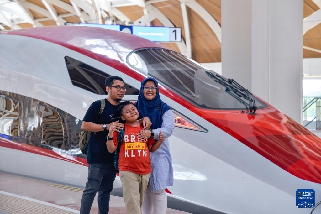 4月17日，在印度尼西亞雅加達(dá)哈利姆站站臺(tái)，乘客和雅萬(wàn)高鐵高速動(dòng)車(chē)組列車(chē)合影。新華社記者 徐欽 攝